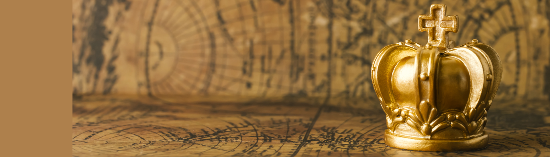 A golden crown sitting on a brown world map